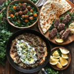 Top-down view of a rustic table showcasing Ground Lamb Recipes with a skillet of cheesy ground lamb topped with yogurt sauce, grilled lamb patties, meatballs on a bed of greens, warm flatbread, lemon wedges, and fresh parsley